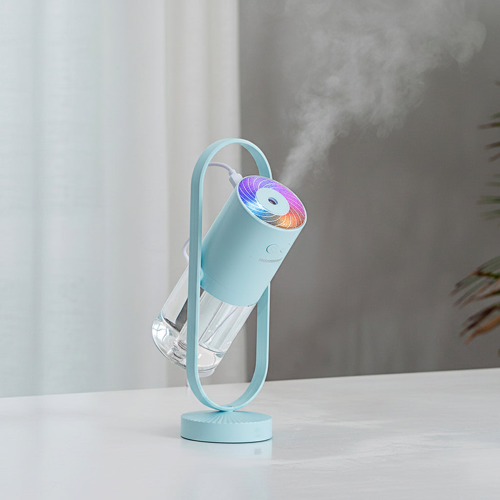 Blue humidifier emitting mist on a white surface with books and a plant in the background