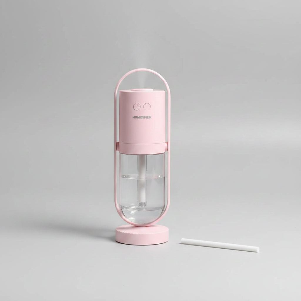 Pink electronic device with a pen-like component on a white background